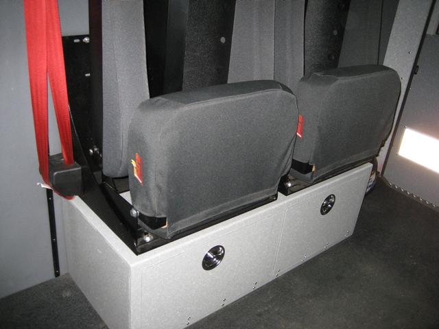 Compartment under forward facing seats